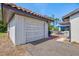 Garage with an outdoor patio featuring a table, chairs, and umbrella, adding to the home's functional and entertainment space at 301 Gulf Dr, Venice, FL 34285