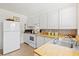 Well-maintained kitchen featuring white appliances, wooden countertops, and ample storage at 301 Gulf Dr, Venice, FL 34285