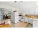 Updated kitchen with white appliances and cabinets, offers a seamless transition to the living area at 301 Gulf Dr, Venice, FL 34285