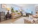 Cozy living room featuring a comfortable sofa, armchairs, and a large window at 301 Gulf Dr, Venice, FL 34285