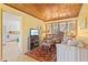 Inviting living room leading to the kitchen features wood ceiling, natural light, patterned rug, and comfortable seating at 301 Gulf Dr, Venice, FL 34285