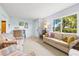 A cozy living room featuring vintage decor, comfortable seating, and a sunny view at 301 Gulf Dr, Venice, FL 34285