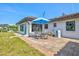 Back patio with dining set near white home and shed at 301 Gulf Dr, Venice, FL 34285