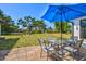 Outdoor patio featuring a dining set with an umbrella at 301 Gulf Dr, Venice, FL 34285