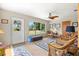 Comfortable sunroom with tile floors, a ceiling fan, and large windows showcasing the backyard at 301 Gulf Dr, Venice, FL 34285