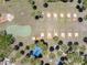 Scenic aerial view highlighting putting greens and horseshoe pits amidst a lush landscape, perfect for leisure and recreation at 304 Roma Rd, Venice, FL 34285