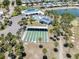 Discover the community's amenities: a pool, shuffleboard court, and putting green surrounded by lush landscaping and a pond at 304 Roma Rd, Venice, FL 34285
