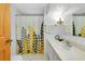 Well-lit bathroom featuring a decorative shower curtain and a marble vanity at 304 Roma Rd, Venice, FL 34285