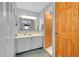 Bathroom featuring white vanity, modern lighting, closet, and a connected bathroom at 304 Roma Rd, Venice, FL 34285