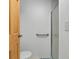 Bathroom with a toilet, grab bar, and a shower with a glass door at 304 Roma Rd, Venice, FL 34285