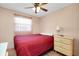 Bedroom featuring a ceiling fan, a window, and a bedside table at 304 Roma Rd, Venice, FL 34285