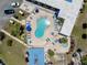 Aerial shot of the sparkling community pool and lounge area, inviting relaxation and social gatherings under the sun at 304 Roma Rd, Venice, FL 34285