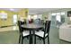 A comfortable dining area that flows into the kitchen and living spaces, with a round table and stylish chairs at 304 Roma Rd, Venice, FL 34285