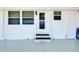 Exterior of the home featuring a covered front porch and a white front door at 304 Roma Rd, Venice, FL 34285
