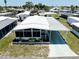 Well-maintained home featuring a driveway, carport and tropical landscaping, offering comfort and curb appeal at 304 Roma Rd, Venice, FL 34285