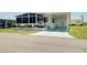 Charming home with well-manicured landscaping, screened porch, and covered parking at 304 Roma Rd, Venice, FL 34285