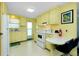 Cozy kitchen that includes appliances, cabinetry and a table with breakfast bar at 304 Roma Rd, Venice, FL 34285