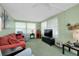 Relaxing and stylish living room with ceiling fan and large windows for natural light at 304 Roma Rd, Venice, FL 34285