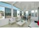 Relaxing sunroom featuring neutral furniture, a ceiling fan, and bright natural light at 304 Roma Rd, Venice, FL 34285