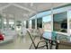 Bright sunroom with a ceiling fan, many windows, and a glass table with four chairs at 304 Roma Rd, Venice, FL 34285