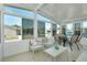 A sunroom featuring seating, tables, and large windows offering plenty of natural light at 304 Roma Rd, Venice, FL 34285