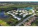 Panoramic aerial of lakeside residences boasting manicured lawns, scenic water views and easy access to community amenities at 3141 Heron Shores Dr, Venice, FL 34293