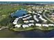 Stunning aerial view of homes nestled among lush greenery and serene lakefronts within a vibrant community at 3141 Heron Shores Dr, Venice, FL 34293