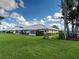 Backyard showcasing a well-maintained lawn and villa exterior at 3141 Heron Shores Dr, Venice, FL 34293