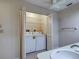Bathroom featuring a toilet, sink, and stackable washer dryer behind a closet door at 3141 Heron Shores Dr, Venice, FL 34293