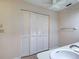 Neutral bathroom with white vanity, sink, toilet and enclosed washer and dryer at 3141 Heron Shores Dr, Venice, FL 34293