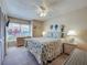 Cozy bedroom featuring a seashell-themed bed set, natural light and a decorative ceiling fan at 3141 Heron Shores Dr, Venice, FL 34293