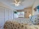 Bedroom boasts a seashell-themed bed set, ample closet space, and a ceiling fan at 3141 Heron Shores Dr, Venice, FL 34293
