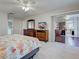 Bedroom with dark wood dressers, ceiling fan, and sliding glass doors leading to the porch at 3141 Heron Shores Dr, Venice, FL 34293
