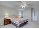 Comfortable bedroom featuring a queen bed with a coral reef-patterned quilt and matching bedside tables at 3141 Heron Shores Dr, Venice, FL 34293