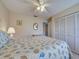 Bright bedroom with a seashell-themed quilt, closet and soft lighting creating a relaxing and comfortable atmosphere at 3141 Heron Shores Dr, Venice, FL 34293