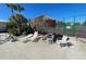 Common area with lounge chairs, shade structure, and tennis court views, great for outdoor relaxation and recreation at 3141 Heron Shores Dr, Venice, FL 34293