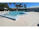 Beautiful community pool surrounded by palm trees, with plenty of room for lounging and soaking up the sun at 3141 Heron Shores Dr, Venice, FL 34293