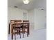 Simple dining area with a wooden table and chairs in a well-lit space at 3141 Heron Shores Dr, Venice, FL 34293