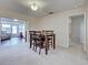 Dining room with a wooden table and chairs with a view into the sunroom at 3141 Heron Shores Dr, Venice, FL 34293