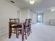 Open concept dining area featuring a wooden table with chairs and ample space for entertaining at 3141 Heron Shores Dr, Venice, FL 34293