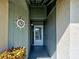 Close-up of the front door with nautical decor and vibrant foliage at 3141 Heron Shores Dr, Venice, FL 34293
