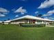 Charming home exterior with well-manicured lawn, lush green hedges, and attached garage under a sunny sky at 3141 Heron Shores Dr, Venice, FL 34293
