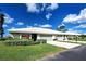 Inviting villa featuring an attached garage, well-manicured lawn, and lush landscaping at 3141 Heron Shores Dr, Venice, FL 34293