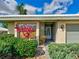 Charming home featuring a beautiful front door with lovely landscaping and a gray-tone exterior at 3141 Heron Shores Dr, Venice, FL 34293