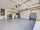 Large garage with ample storage cabinets, utility sink, and plenty of open space at 3141 Heron Shores Dr, Venice, FL 34293