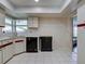 Bright kitchen features white cabinetry, a black dishwasher, and tiled flooring at 3141 Heron Shores Dr, Venice, FL 34293