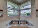 Kitchen sink with a double basin and a window view of the neighborhood at 3141 Heron Shores Dr, Venice, FL 34293
