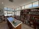 Well-lit community library featuring organized bookshelves and a large table for studying and reading at 3141 Heron Shores Dr, Venice, FL 34293