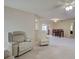 Bright living room featuring comfortable recliners, neutral decor, and seamless transition to the dining area for entertaining at 3141 Heron Shores Dr, Venice, FL 34293