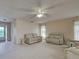 Open living room featuring comfortable seating, natural light, and a view towards the entryway at 3141 Heron Shores Dr, Venice, FL 34293